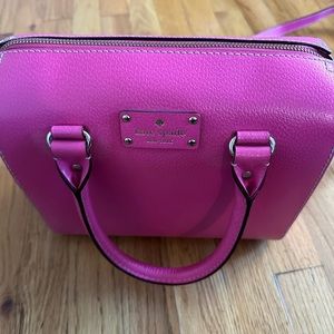 Pink Kate Spade bag with top handle and shoulder strap